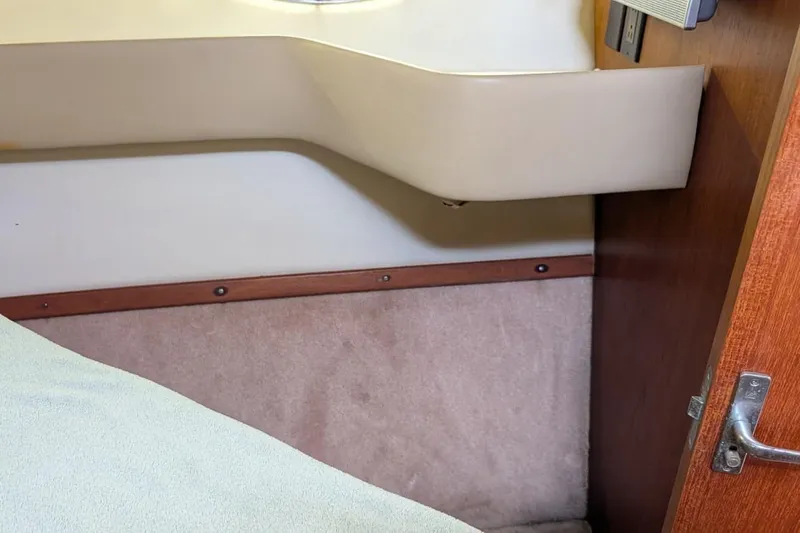 Slide: The Image of Interior cabin detail of a 1998 Tiara Yachts 4100 Open, featuring wood and beige accents. - 21