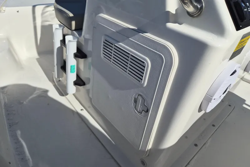 Slide: The Image of 2026 Key West 1720 Center Console boat interior with storage compartment and rod holders. - 10