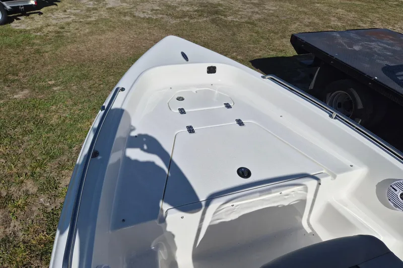 Slide: The Image of 2026 Key West 1720 Center Console boat deck, white finish, parked on grass. - 11