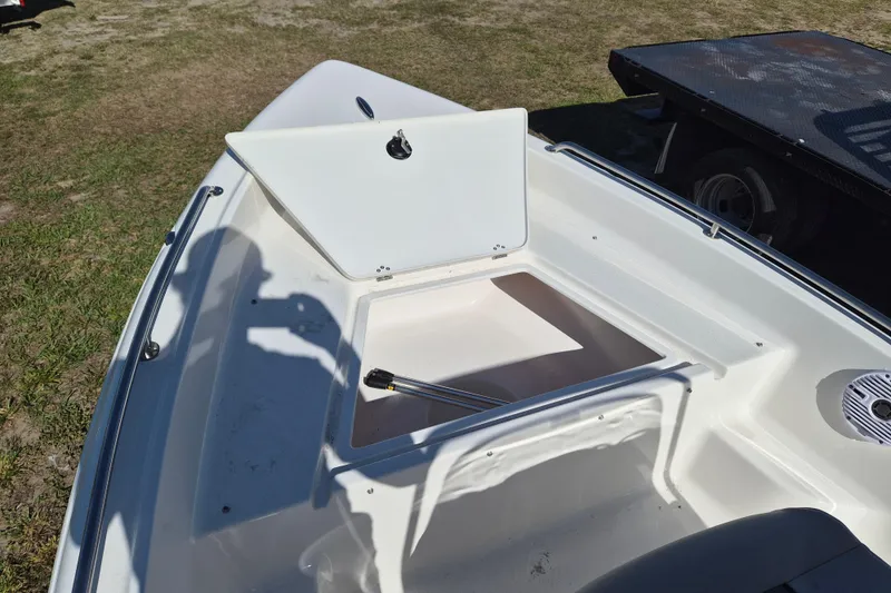Slide: The Image of 2026 Key West 1720 Center Console boat with open storage compartment on deck. - 12