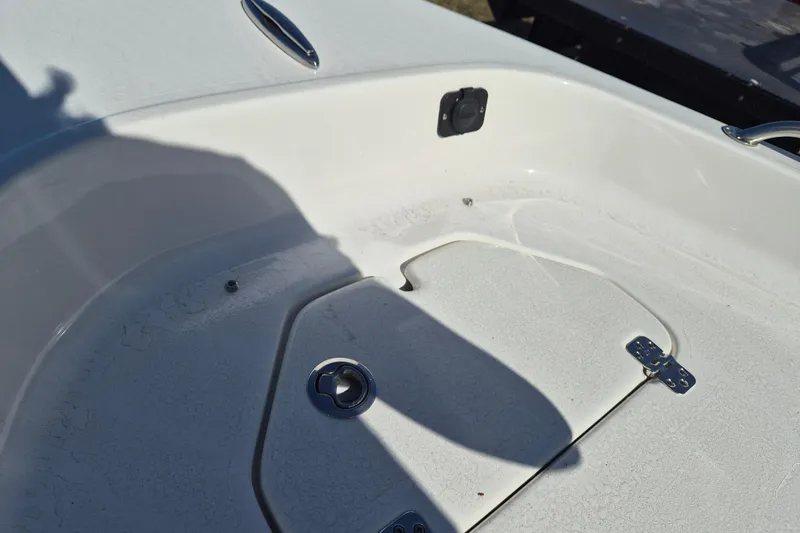 Slide: The Image of 2026 Key West 1720 Center Console boat deck with storage compartment and latch. - 13