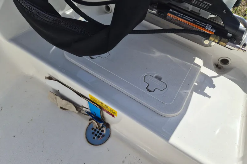 Slide: The Image of 2026 Key West 1720 Center Console boat interior with storage compartment and hydraulic steering. - 16