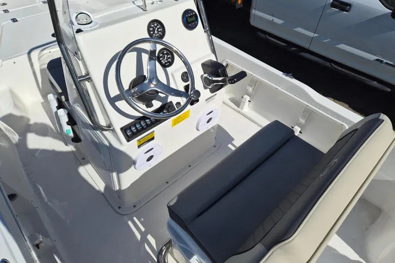 Slide: The Image of 2026 Key West 1720 Center Console boat interior with steering wheel and seating. - 6