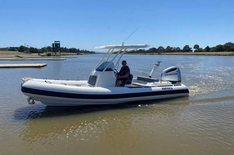 Slide: The Image of 2026 Brig Eagle 6.7 boat with Honda engine cruising on a calm river. - 11