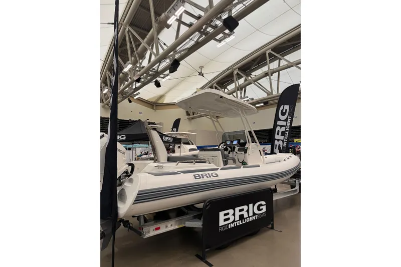 Slide: The Image of 2026 Brig Eagle 6.7 boat displayed indoors with promotional banners. - 16