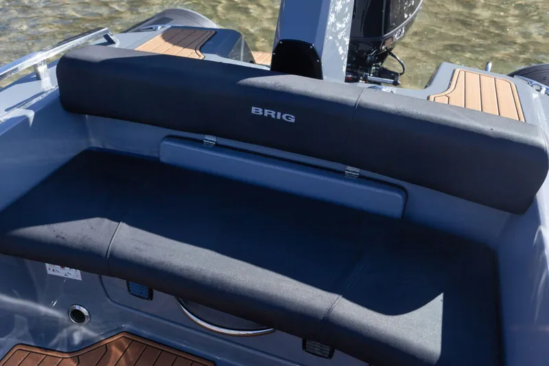 Slide: The Image of 2026 Brig Eagle 6.7 boat interior with cushioned seating and teak flooring. - 8