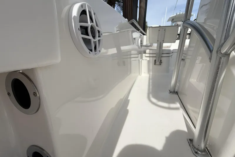 Slide: The Image of 2021 Robalo R200 Center Console boat interior with speaker and railing details. - 11