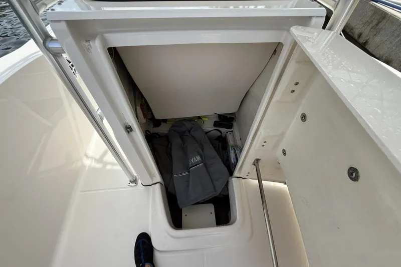 Slide: The Image of Storage compartment of 2021 Robalo R200 Center Console boat with gear and equipment. - 13