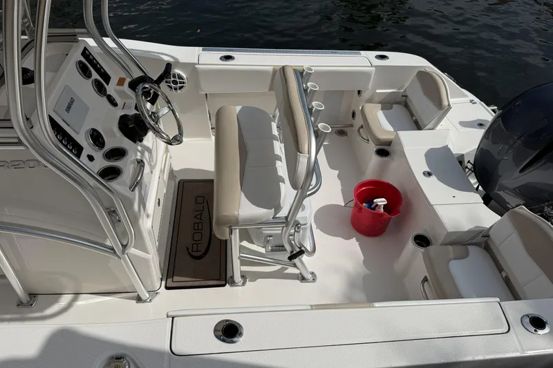 Slide: The Image of 2021 Robalo R200 Center Console boat interior with steering wheel and seating. - 14