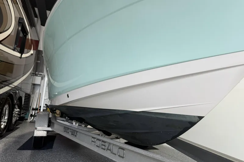 Slide: The Image of 2021 Robalo R200 Center Console boat on trailer in garage. - 15