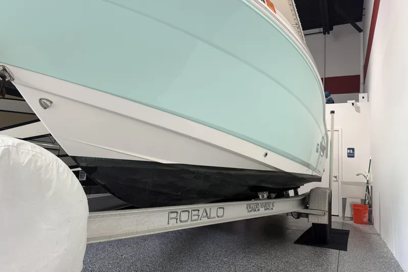 Slide: The Image of 2021 Robalo R200 Center Console boat on trailer in indoor storage. - 16
