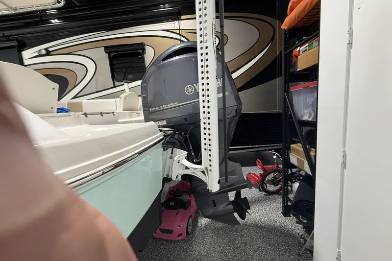 Slide: The Image of 2021 Robalo R200 Center Console boat with Yamaha outboard motor in a garage. - 19