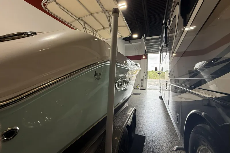 Slide: The Image of 2021 Robalo R200 Center Console boat in storage beside an RV. - 20