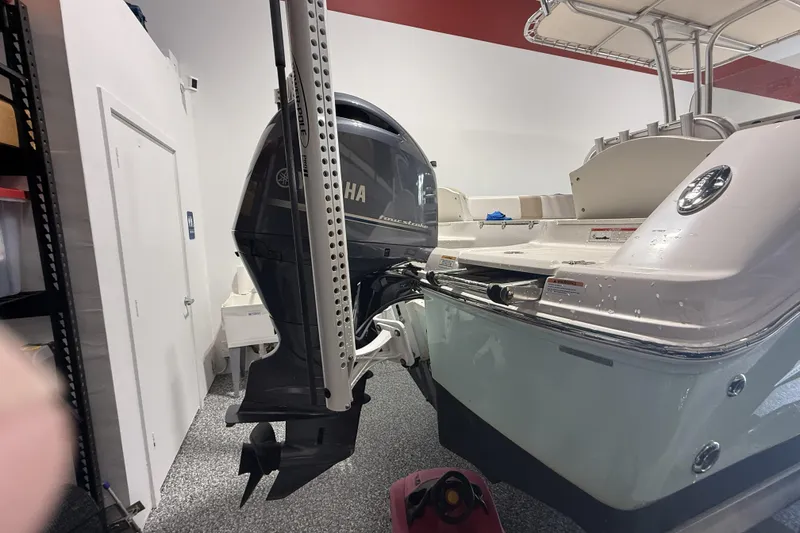Slide: The Image of 2021 Robalo R200 Center Console boat with Yamaha outboard motor in a garage. - 21