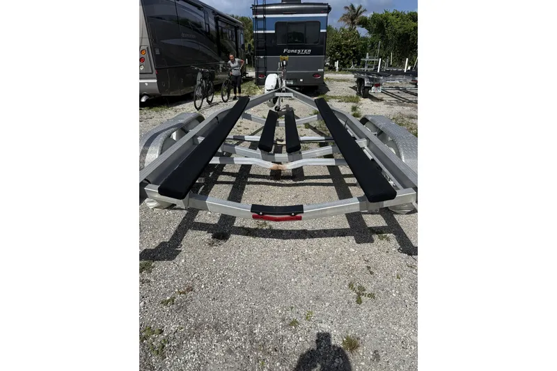 Slide: The Image of Boat trailer for 2021 Robalo R200 Center Console, parked near RVs and bicycles. - 23