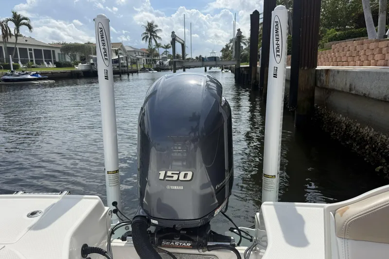 Slide: The Image of 2021 Robalo R200 Center Console with Yamaha 150 engine, docked in a scenic canal. - 24