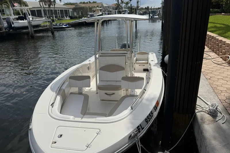 Slide: The Image of 2021 Robalo R200 Center Console boat docked in a serene canal setting. - 3
