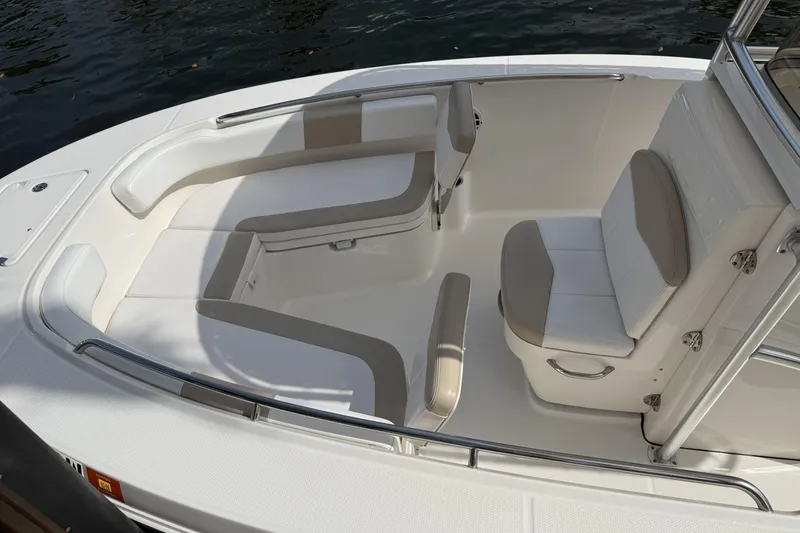 Slide: The Image of 2021 Robalo R200 Center Console boat interior with cushioned seating and stainless steel railings. - 4