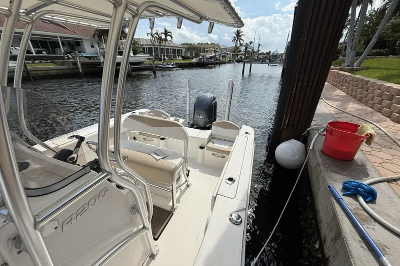 Slide: The Image of 2021 Robalo R200 Center Console boat docked by waterfront homes. - 8