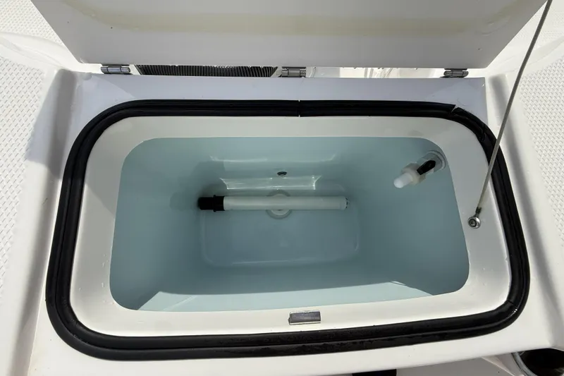 Slide: The Image of 2021 Robalo R200 Center Console livewell with open lid, showcasing interior features. - 9