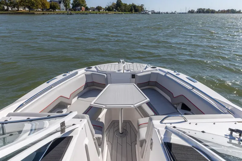 Slide: The Image of Manufacturer Provided Image: 2026 Solara S-250 DC boat interior with seating and table on calm water. - 2