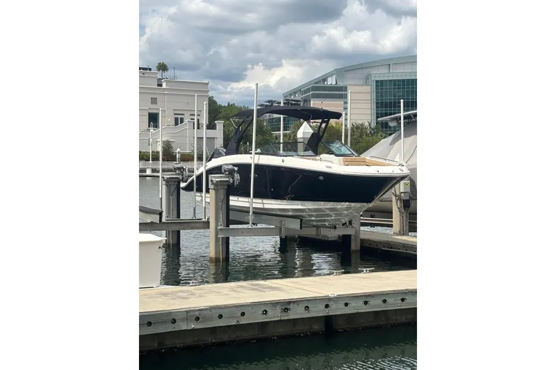 The Image of 2019 Sea Ray SDX 270 Outboard boat docked at marina under cloudy sky. - 0