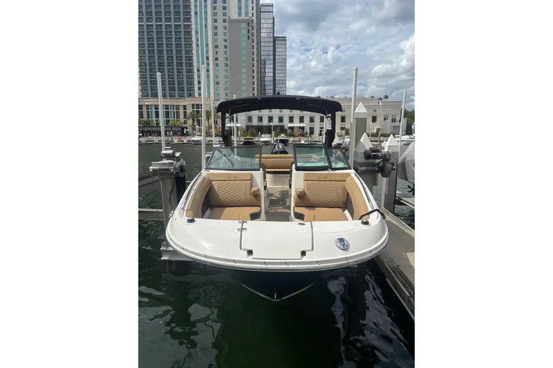 Slide: The Image of 2019 Sea Ray SDX 270 Outboard boat docked in urban marina setting. - 3