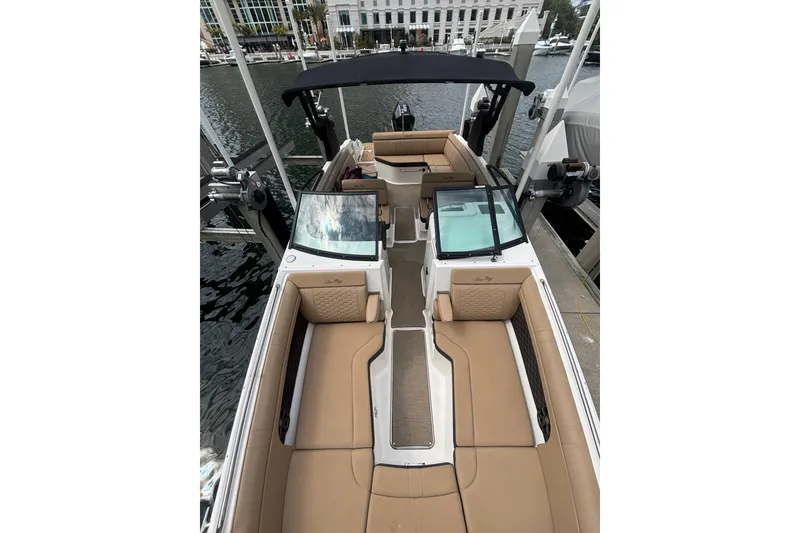 Slide: The Image of 2019 Sea Ray SDX 270 Outboard boat with tan seating, docked at marina. - 5