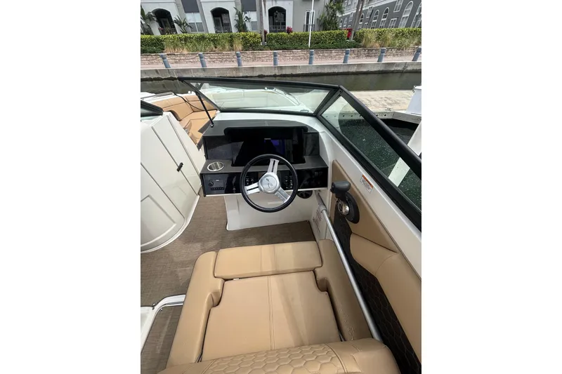 Slide: The Image of 2019 Sea Ray SDX 270 Outboard boat interior with steering wheel and seating. - 7