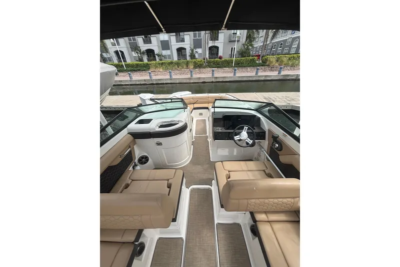 Slide: The Image of 2019 Sea Ray SDX 270 Outboard boat interior with tan seating and modern dashboard. - 8
