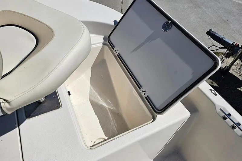 Slide: The Image of 2022 Carolina Skiff 178 JLS boat storage compartment with open lid and seat. - 12