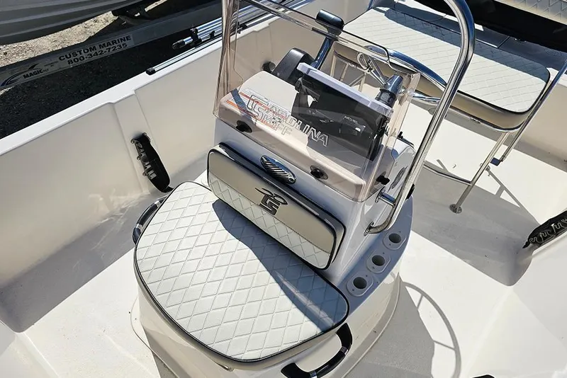 Slide: The Image of 2022 Carolina Skiff 178 JLS boat interior with cushioned seating and steering console. - 15