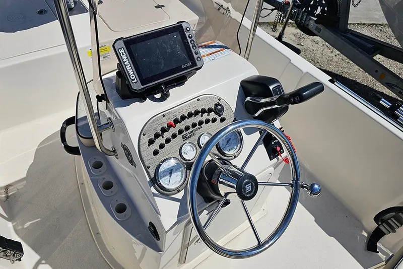 Slide: The Image of 2022 Carolina Skiff 178 JLS boat console with steering wheel and Lowrance Elite display. - 17