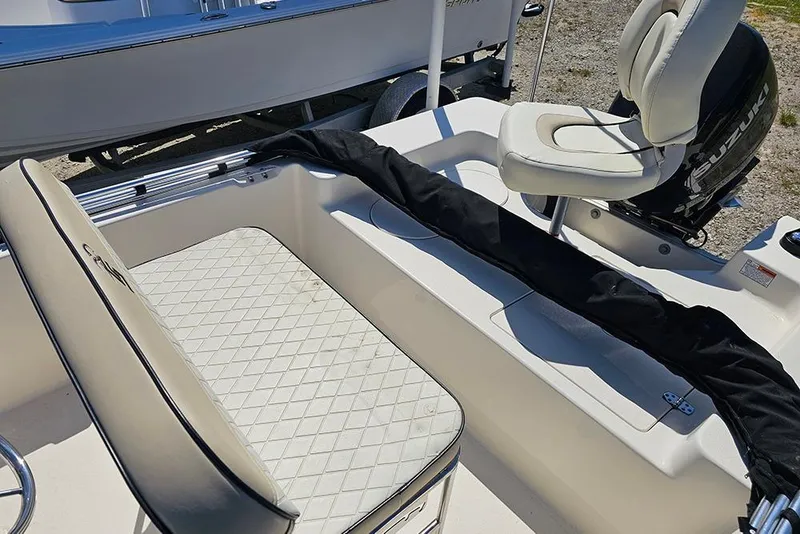 Slide: The Image of 2022 Carolina Skiff 178 JLS boat interior with seating and Suzuki outboard motor. - 19