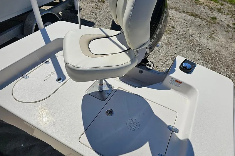 Slide: The Image of 2022 Carolina Skiff 178 JLS boat interior with cushioned seat and storage compartment. - 20