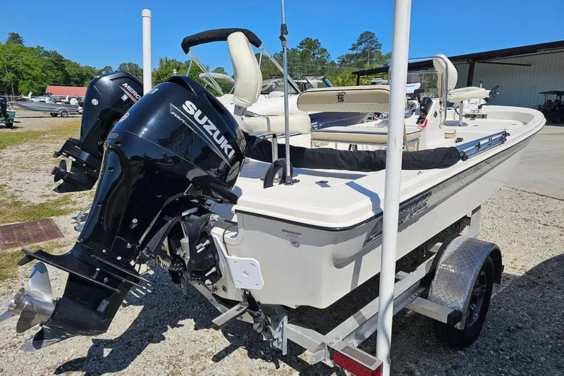 Slide: The Image of 2022 Carolina Skiff 178 JLS boat with Suzuki outboard motor on trailer. - 4