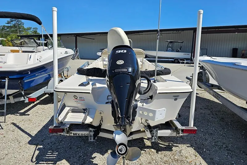 Slide: The Image of 2022 Carolina Skiff 178 JLS boat with 90 HP outboard motor, parked on a trailer. - 9