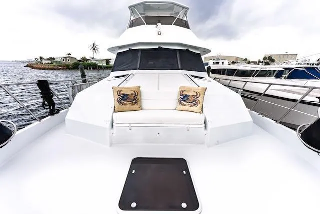 Slide: The Image of 1999 Hatteras 74 Sport Deck Motor Yacht helm with dual white captain chairs. - 10