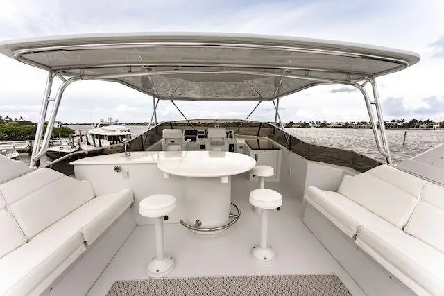 Slide: The Image of Luxurious interior of 1999 Hatteras 74 Sport Deck Motor Yacht with elegant dining area. - 21