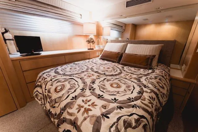Slide: The Image of Luxurious bathroom in 1999 Hatteras 74 Sport Deck Motor Yacht with granite countertop and glass shower. - 33