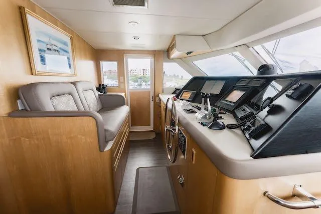Slide: The Image of Cockpit of 1999 Hatteras 74 Sport Deck Motor Yacht with navigation instruments and controls. - 38