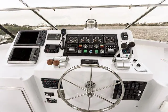 Slide: The Image of Stern view of 1999 Hatteras 74 Sport Deck Motor Yacht docked, featuring American flag. - 42