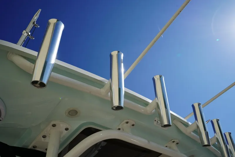 Slide: The Image of 2024 Edgewater 285CC boat rod holders against clear blue sky. - 12