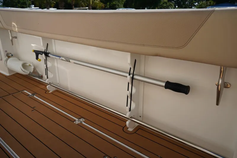 Slide: The Image of 2024 Edgewater 285CC boat interior with rod holder and teak flooring. - 14