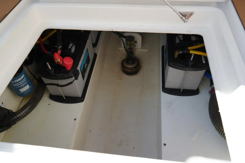 Slide: The Image of 2024 Edgewater 285CC boat battery compartment with Yamaha filter and wiring. - 15