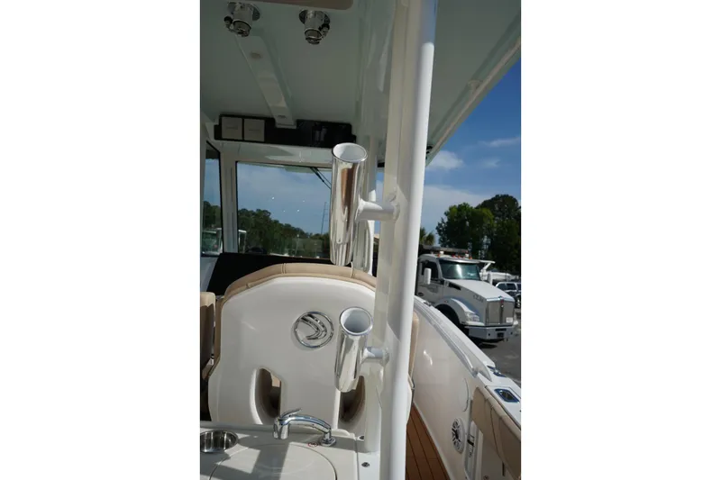 Slide: The Image of 2024 Edgewater 285CC boat interior with rod holders and seating, showcasing luxury design. - 17