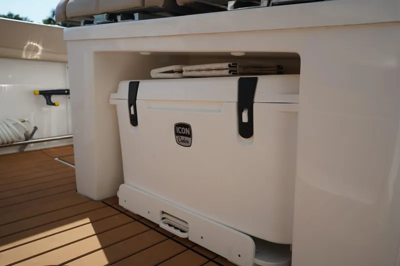 Slide: The Image of 2024 Edgewater 285CC boat with Icon cooler stored under seat. - 19