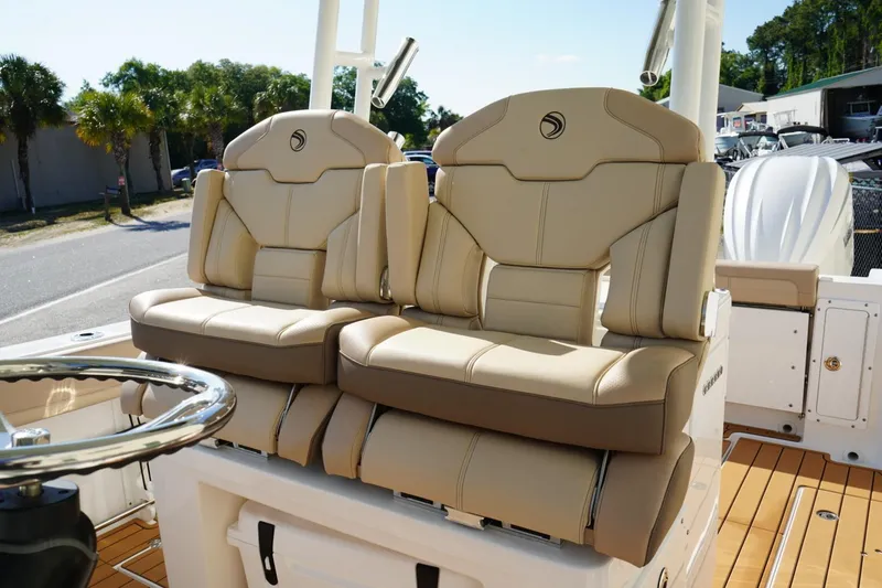 Slide: The Image of 2024 Edgewater 285CC boat with luxurious beige seating and sleek design. - 20