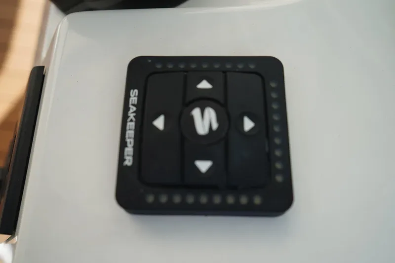 Slide: The Image of Seakeeper control panel on 2024 Edgewater 285CC boat dashboard. - 27