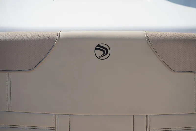 Slide: The Image of 2024 Edgewater 285CC boat seat with logo, featuring beige upholstery. - 37